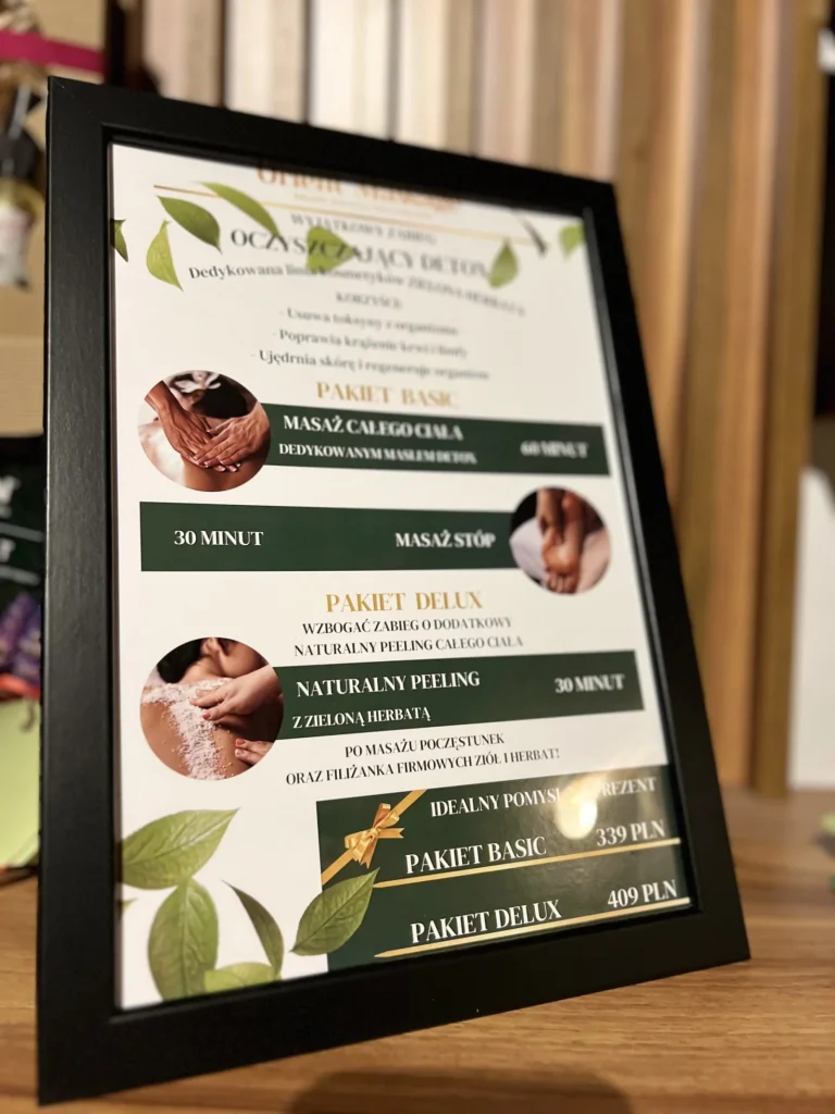 Plakat z ofertą pakietów SPA w czarnej ramce.